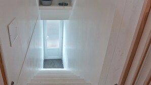 A narrow stairway leading to a small landing with a door at the top. - 1 bedroom nice apartment in Carolles (Carolles)