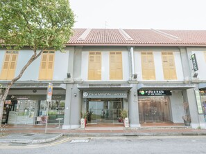 A hotel with a traditional facade, featuring a tiled roof and wooden shutters. - A Hotel Joo Chiat Stay from 7PM to 9AM (Singapore)