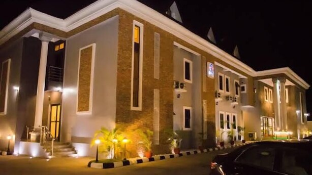 A hotel with a symmetrical facade, large windows, and a well-lit entrance. - Fancourt Hotel (Ilorin)