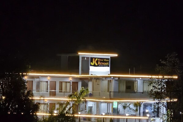 A multi-story hotel with a prominent sign for "River View Resort." - Ditya Destiny's JK River View Resort (Yamkeshwar)