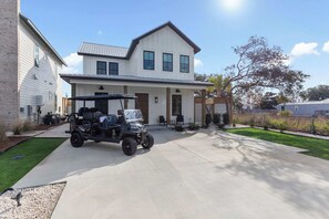 A two-story house with a covered garage and a driveway.