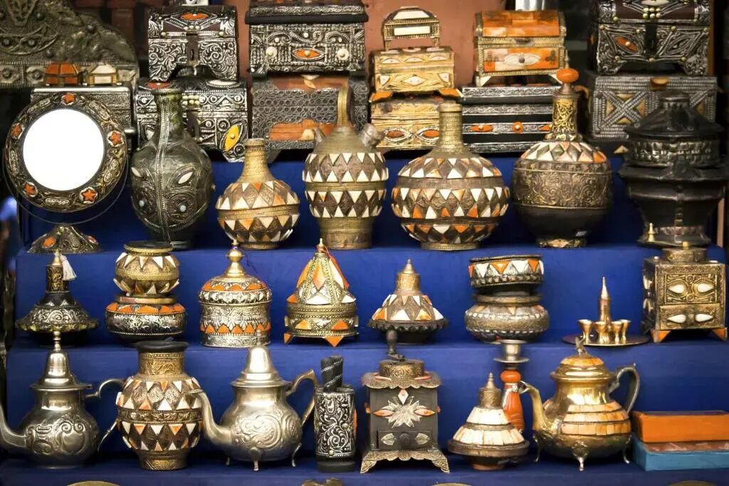 A variety of ornate metal containers and decorative items, likely for sale.