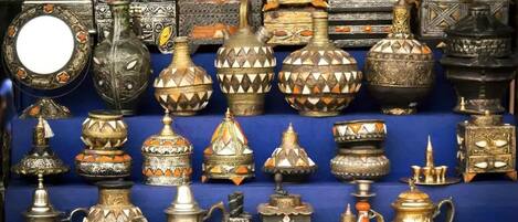 A variety of ornate metal containers and decorative items, likely for sale.