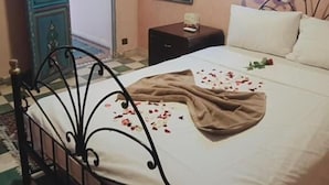 A bedroom with a bed, a dresser, a mirror, and an air conditioning unit. - Riad Wink (Marrakech)