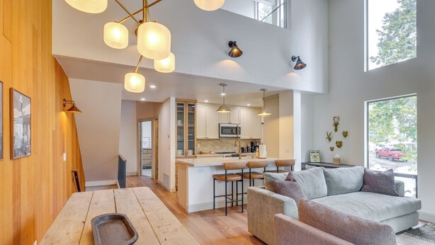 A modern kitchen with a central island, bar stools, and a dining table with a tray. - Kings Beach Retreat Near Lake Tahoe w/ Pool Access (Kings Beach)