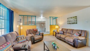 A living room with two brown leather sofas, a wooden coffee table, and patterned cushions. - 11 Mi to Skiing: Valdez Home w/ Mtn Views! (Arroyo Seco)