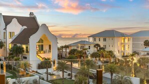A beachfront hotel with multiple buildings, a well-maintained garden, and a view of the ocean. - 1 HOUSE OFF THE BEACH! Private Pool, LSV/Golf Cart, Bikes, Games, Gym! Sleeps 22! (Santa Rosa Beach)