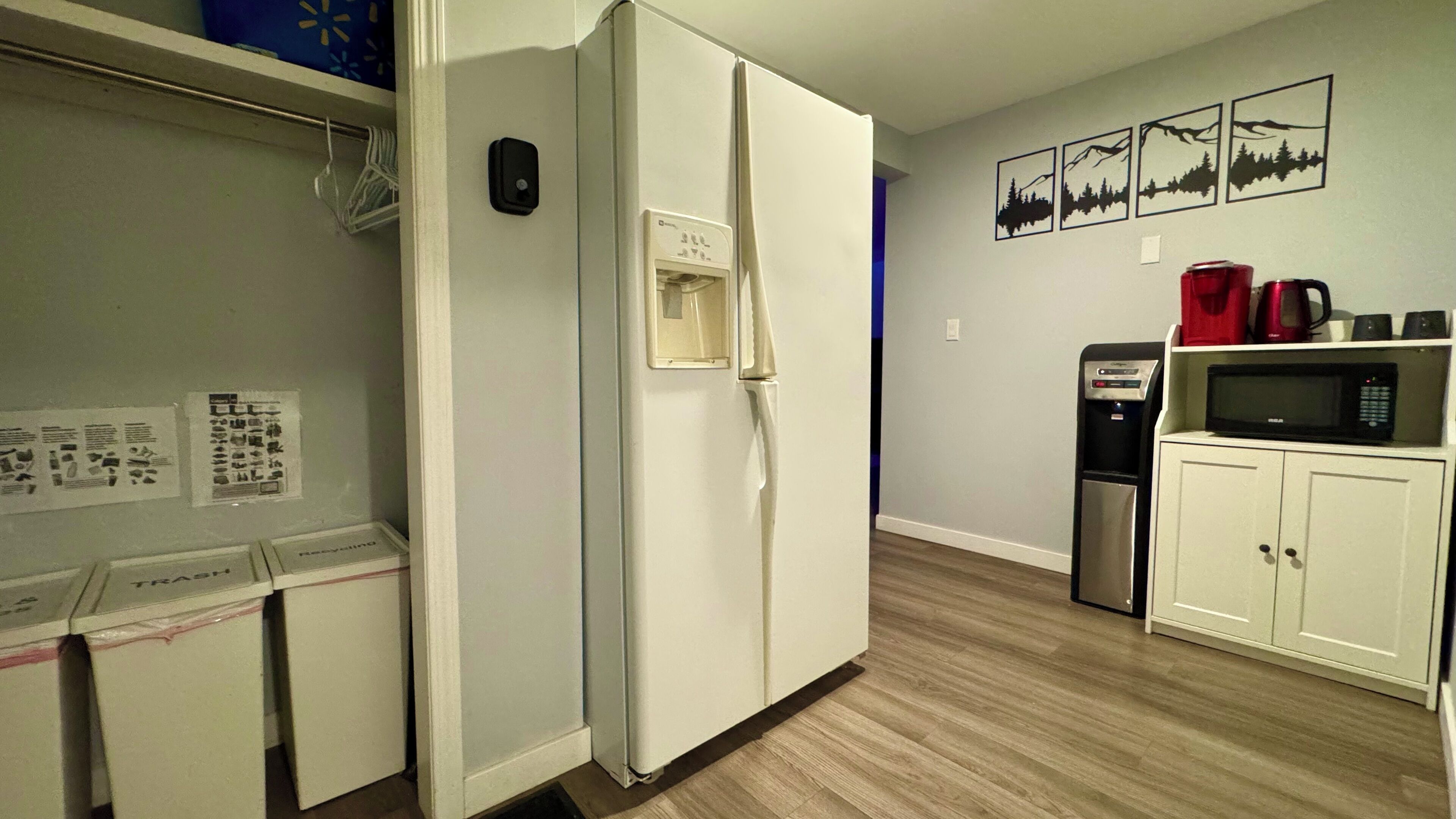 A compact kitchen with a refrigerator, microwave, and coffee maker.