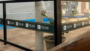 A wooden pergola structure with a pool table and a sign for Village Comfort Hotel. - Village Comfort Hotel (Caninde de Sao Francisco)