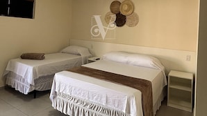 A hotel room with two beds, a nightstand, a wall-mounted air conditioner, and a ceiling light. - Village Comfort Hotel (Caninde de Sao Francisco)