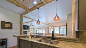 A kitchen with granite countertops, stainless steel appliances, and wooden cabinets. - Private Hot Tub, Views, Summer Adventures (Keystone)