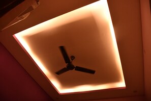 Un ventilador de techo con una lámpara cuadrada.