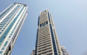 Two high-rise buildings with a clear sky.