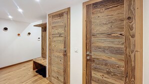 A hallway with wooden doors and a bench. - Tamaris - Morzine - secteur Planet (Morzine)