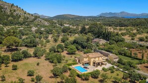 A large house with a swimming pool, surrounded by trees and mountains in the background. - Can Pansa - Three Bedroom Villa, Sleeps 6 (Pollensa)