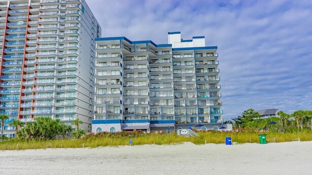 A multi-story hotel with balconies, located near a beach. - Bluewater Resort 1205 (Myrtle Beach)