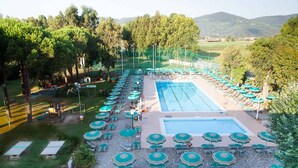 A pool area with multiple swimming pools, sun loungers, and umbrellas. - Residence with pool in Luni Mare (Luni)