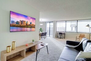 Apartment, Balcony, City View | Living area | 50-inch plasma TV with cable channels