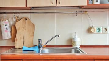 Fridge, microwave, cleaning supplies