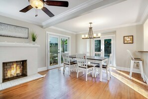 Cozy living space with a fireplace, dining area, and large window.