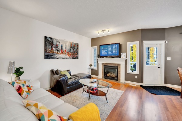 This is the mainfloor living room, complete with a gas fireplace and large Smart TV connected to cable.