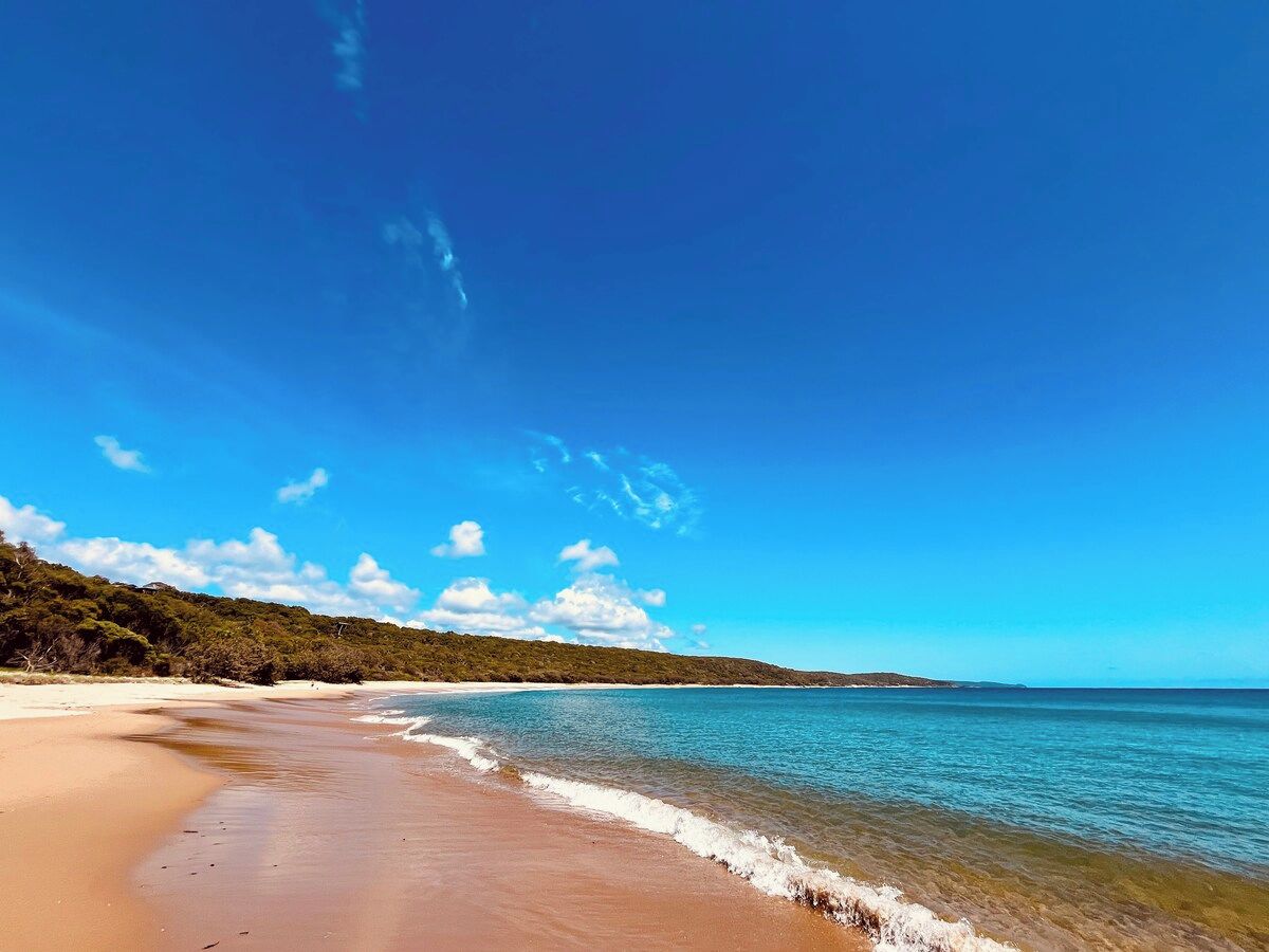A beach with clear skies and calm waters.