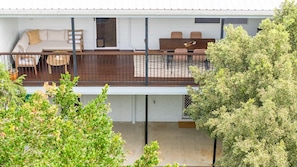 A two-story house with a balcony, a dining area, and a living room.