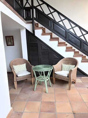 A staircase with black railings and brown steps, leading to an upper level.