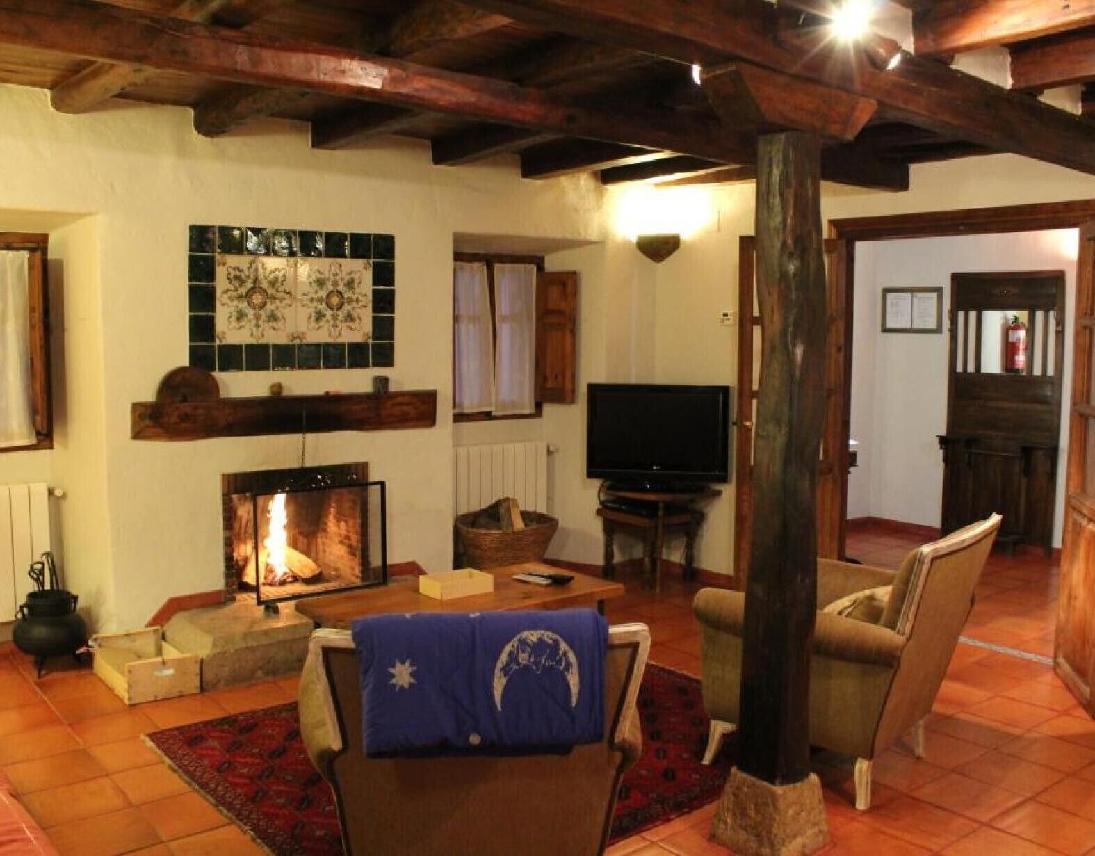 A cozy living room with a fireplace, a television, and comfortable seating.
