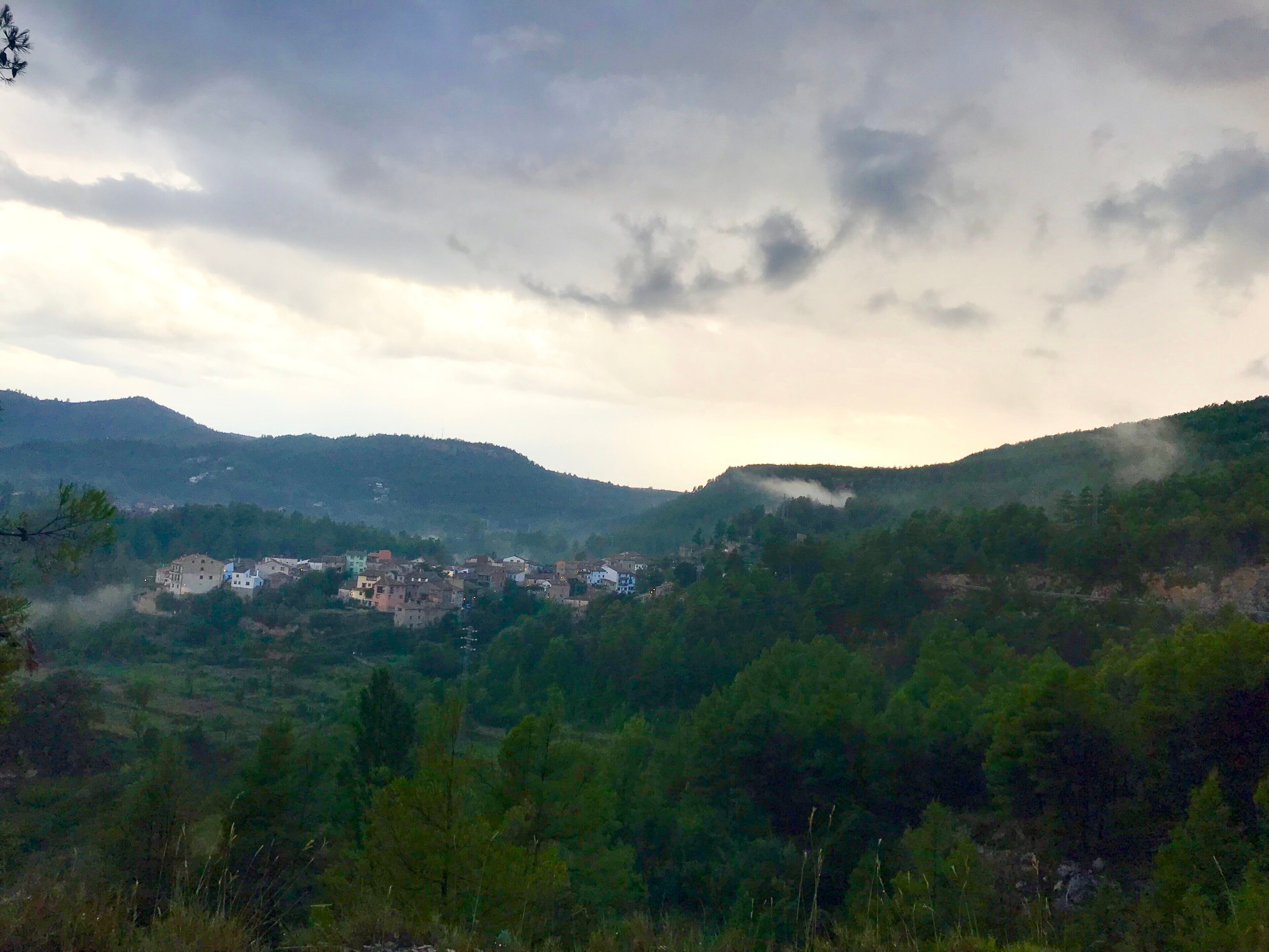 A mountainous landscape with a small settlement.