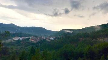 A mountainous landscape with a small settlement.