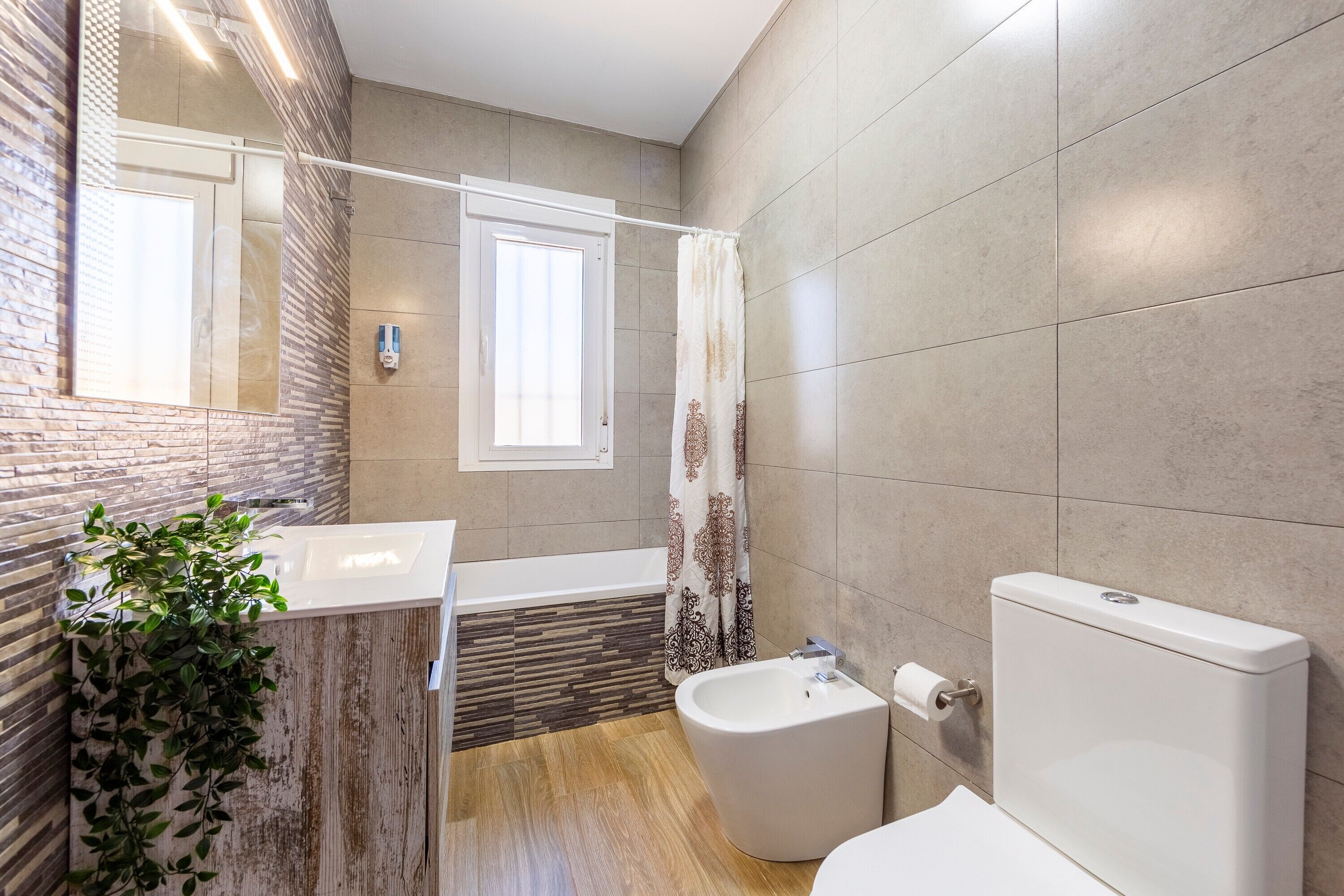 A bathroom with a bathtub, toilet, and sink.