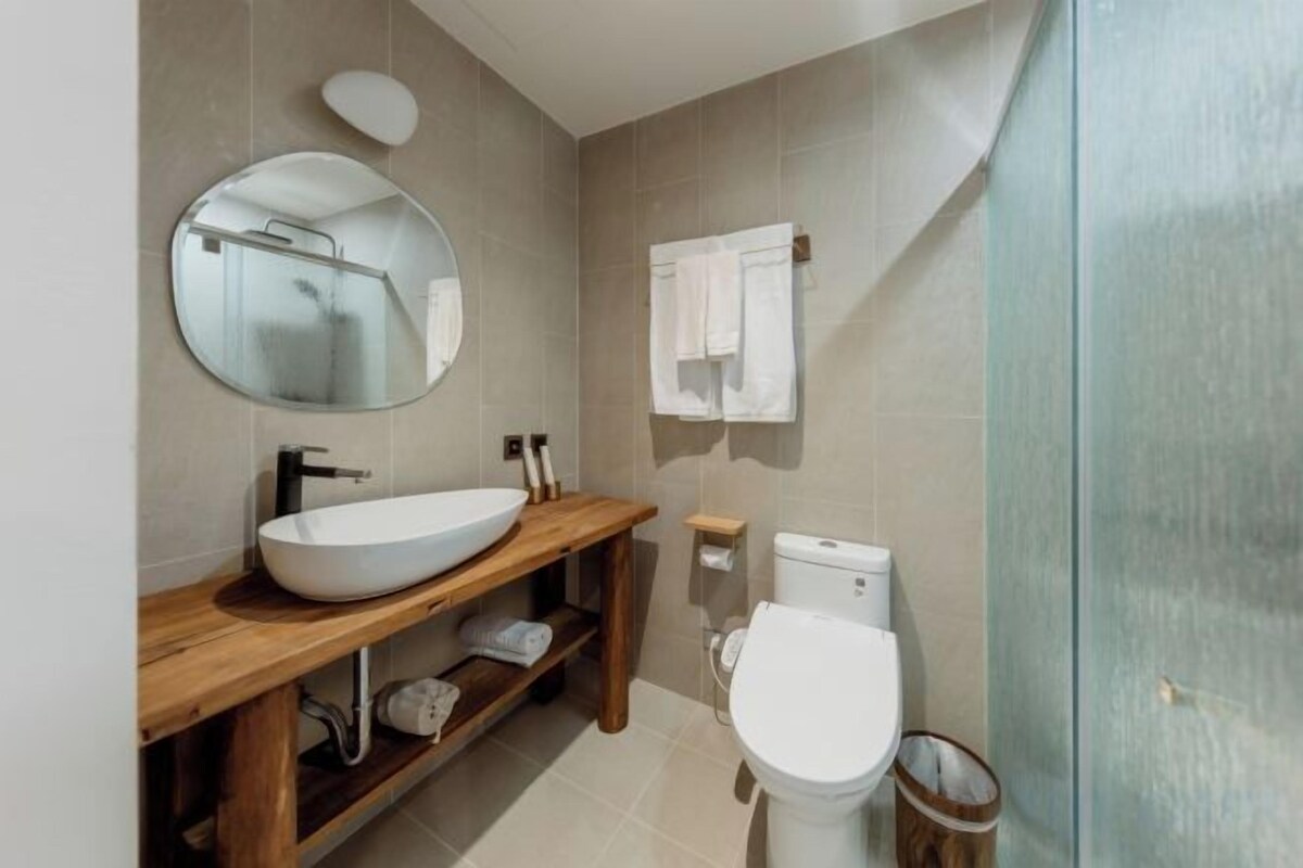 Bathroom | Rainfall showerhead, hair dryer, towels, shampoo