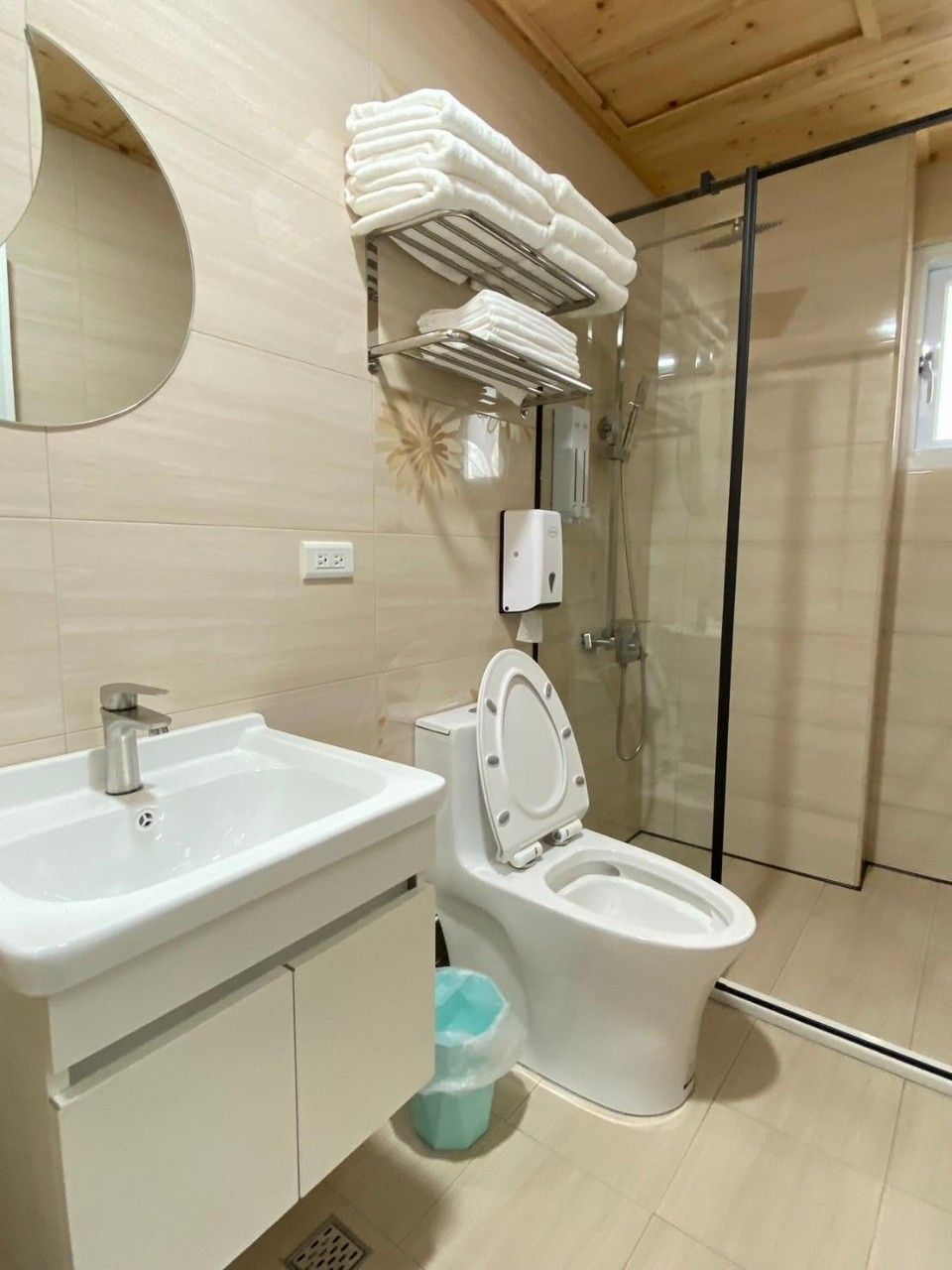 A bathroom with a sink, toilet, and a glass shower enclosure.