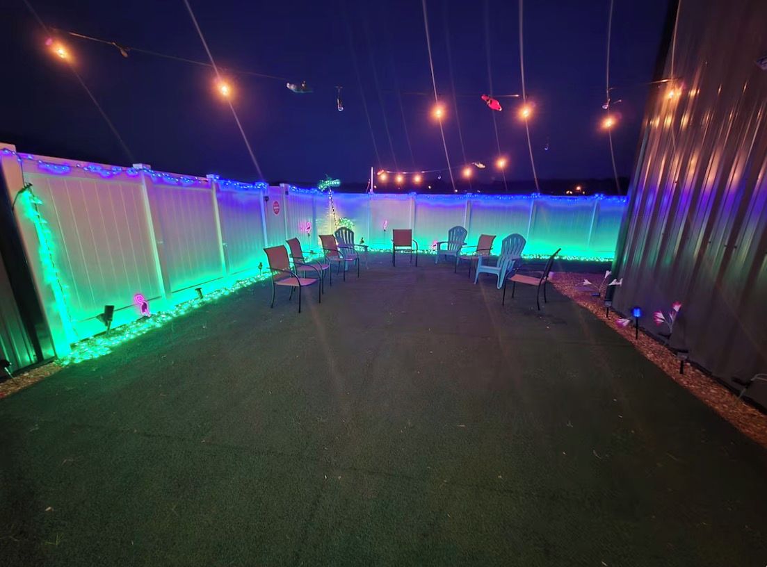 An outdoor patio area with chairs and string lights.