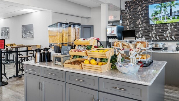 A modern kitchen area with a buffet setup, including various food items and a coffee station. - Condo at the Bay with Resort-Style Amenities, Pool, Tiki Bar (Sarasota)