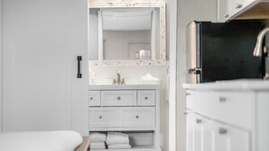 A bathroom with a white vanity, a mirror, and a sink. - Condo at the Bay with Resort-Style Amenities, Pool, Tiki Bar (Sarasota)