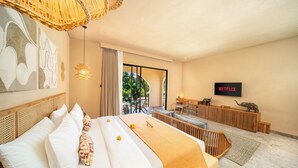 A hotel room with a large bed, a desk, a TV, and a view of the outdoors. - Cabana Kedungu by Ini Vie Hospitality  (Tabanan)