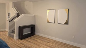 A staircase leading to a second floor, a dark console table, and two framed artworks on the wall. - Serenity I, Luxurious get-away, Pool, WIFI (Princeton)