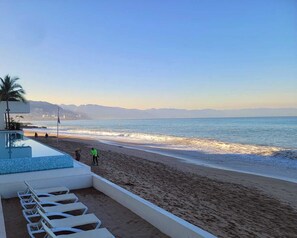 On the beach, sun loungers, beach towels