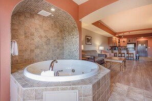 A spacious bathroom with a large bathtub, a shower area, and a tiled wall. - Chula Vista Resort Condo (Wisconsin Dells)