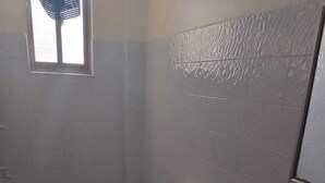A small bathroom with a toilet, sink, and a window.
