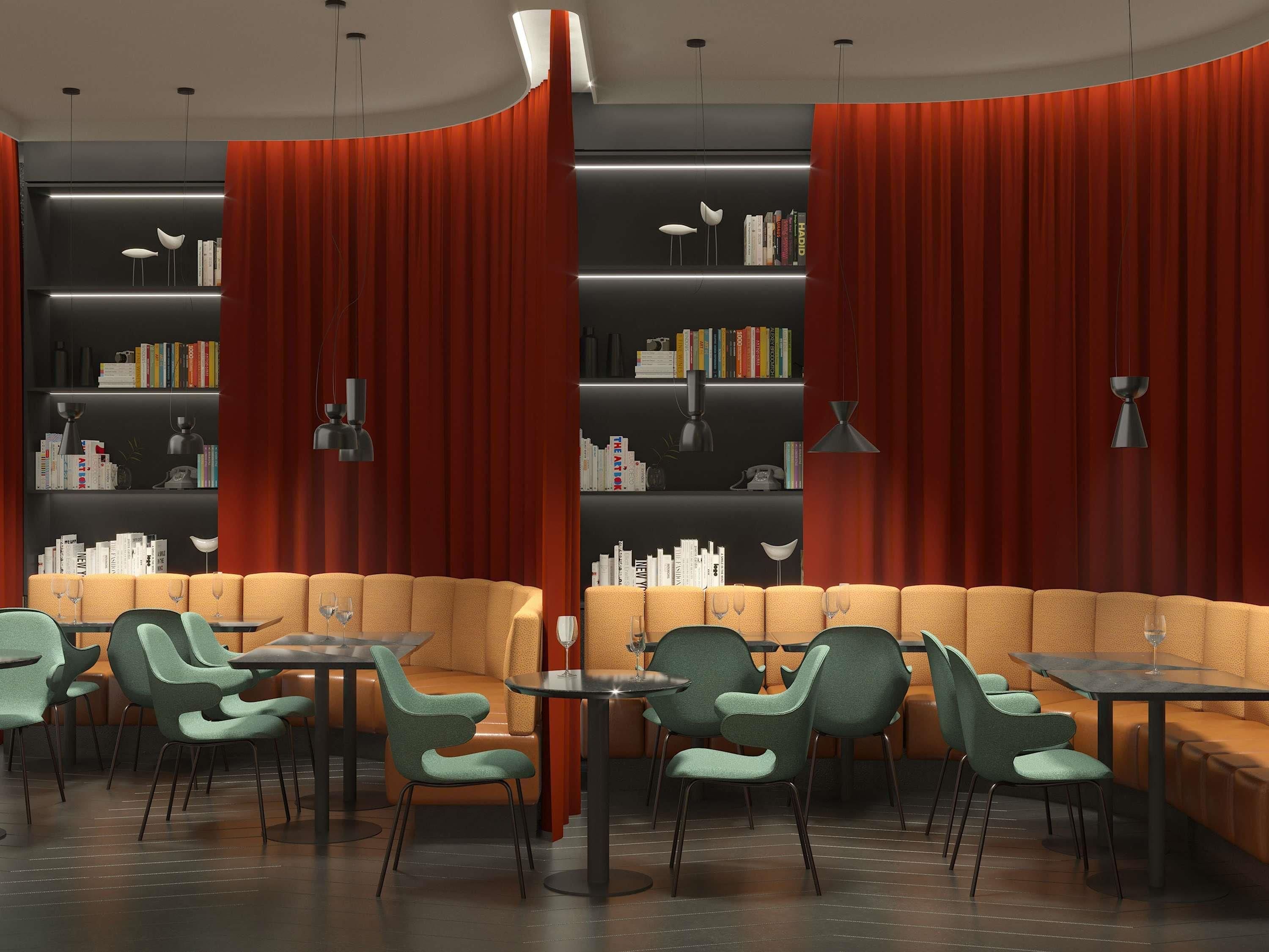 A modern library with bookshelves, a sofa, and tables.
