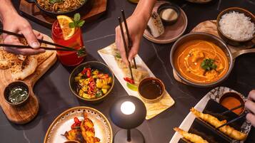 A variety of dishes including noodles, curry, and fried items, suggesting a diverse dining experience.