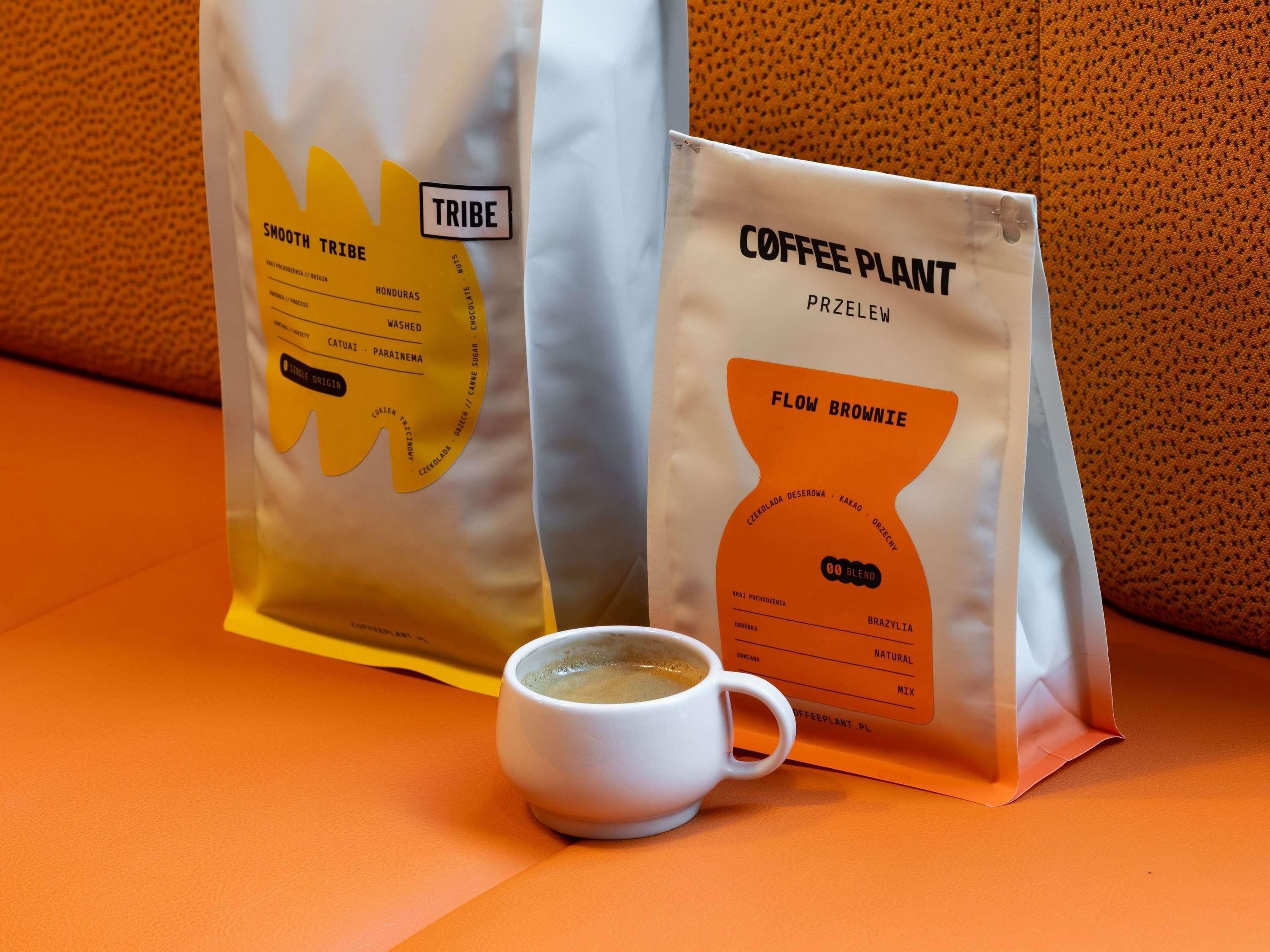 Two coffee bags and a cup of coffee on a table.