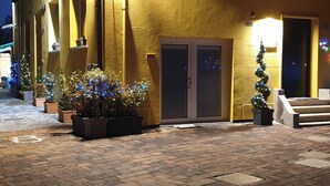 A building with a yellow facade, a double door entrance, and a staircase leading up to the entrance. - 3 Lofts for 9 People, Abete 3p, Noce 4p, Rovere 2p (Castel San Pietro Terme)