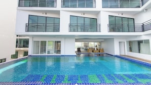 A multi-story building with a swimming pool. - Bear & Bird Hotel   (Surat Thani)