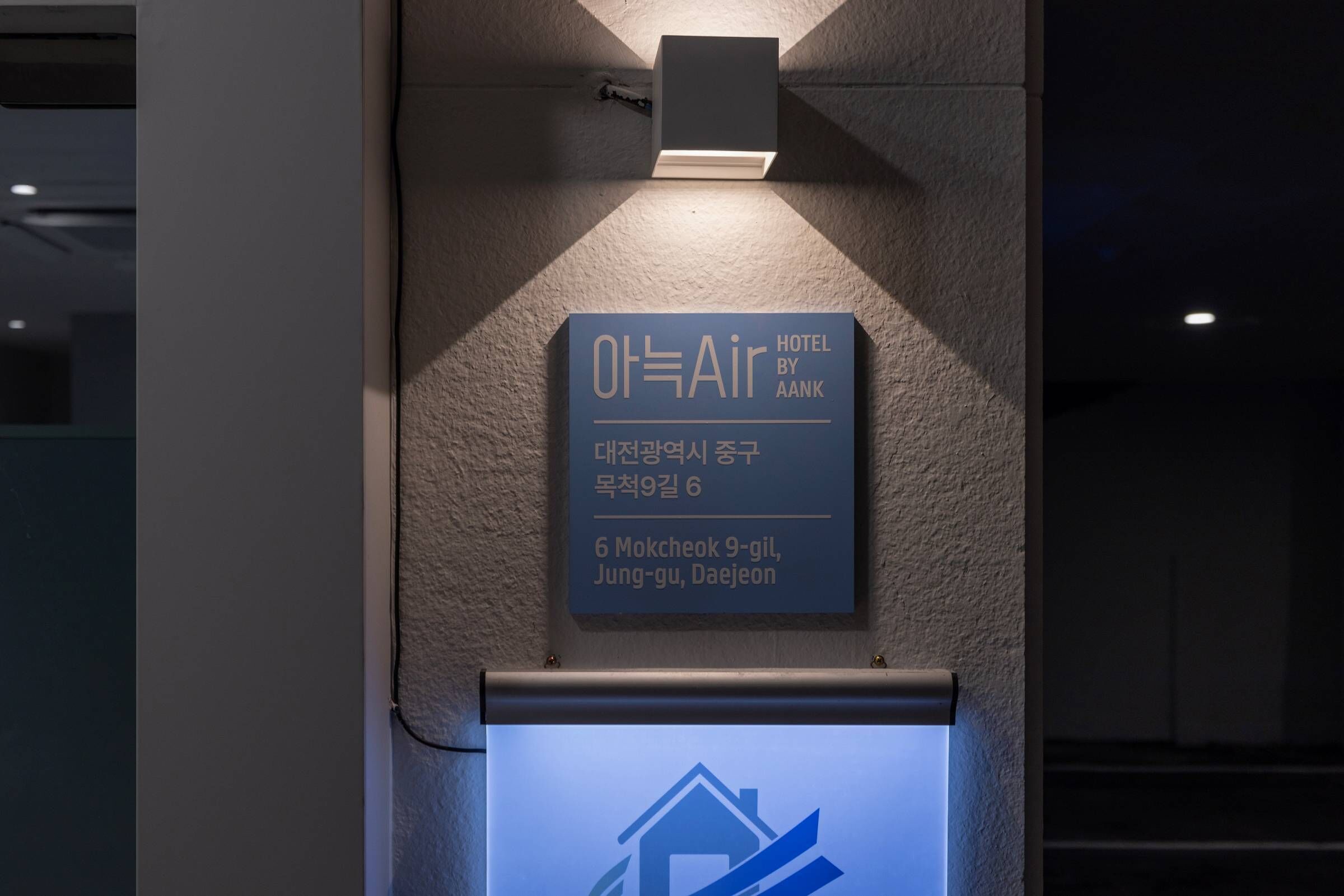Un letrero para 'Air Hotel by AANK' con un icono de edificio debajo.