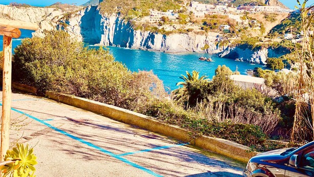 A coastal road with a view of cliffs and the sea. - Ponzamania Sea urchin (Le Forna)