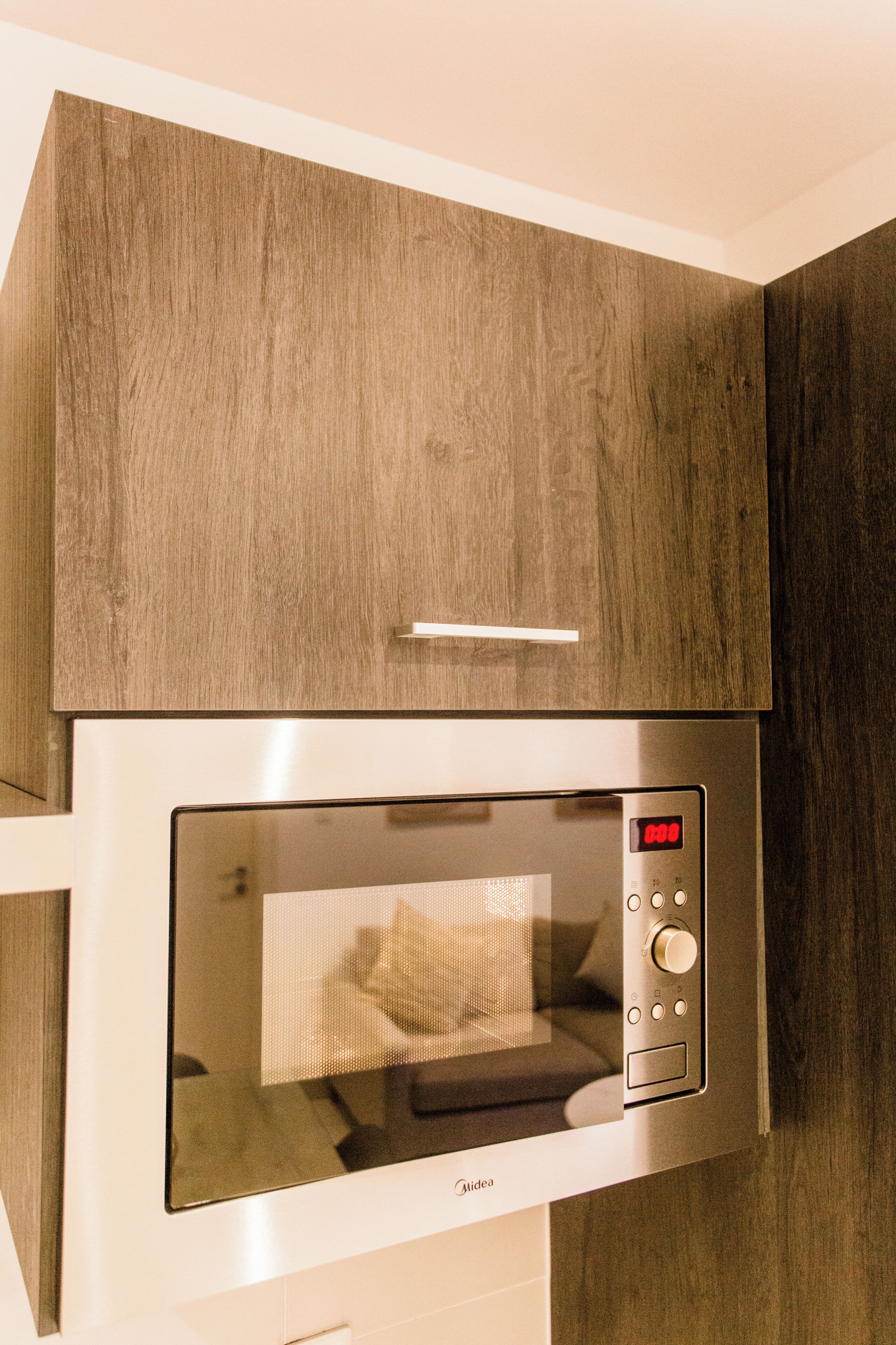 A modern kitchen with a built-in microwave oven.